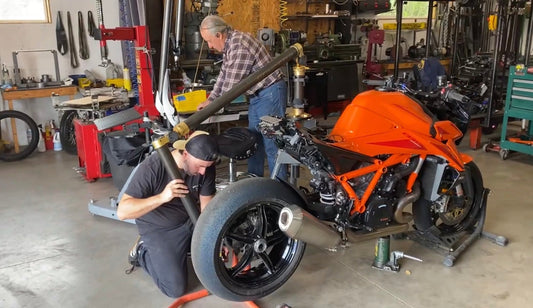 Gerry Piazza using his digital arm chassis measuring machine on a KTM Gen4 Superduke in his workshop